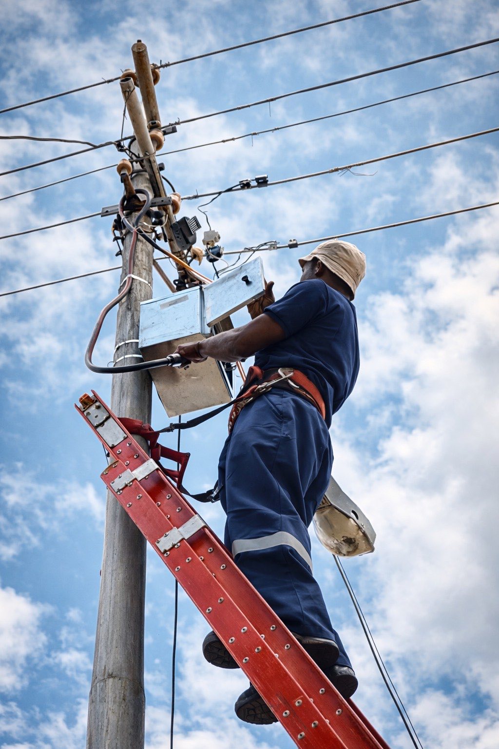 Electrical technician working on a utility pole